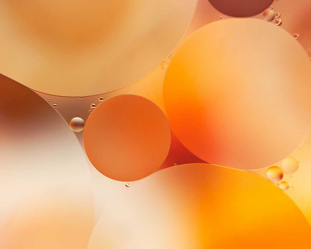 Backlit macro of an orange slice with glowing juice vesicles
